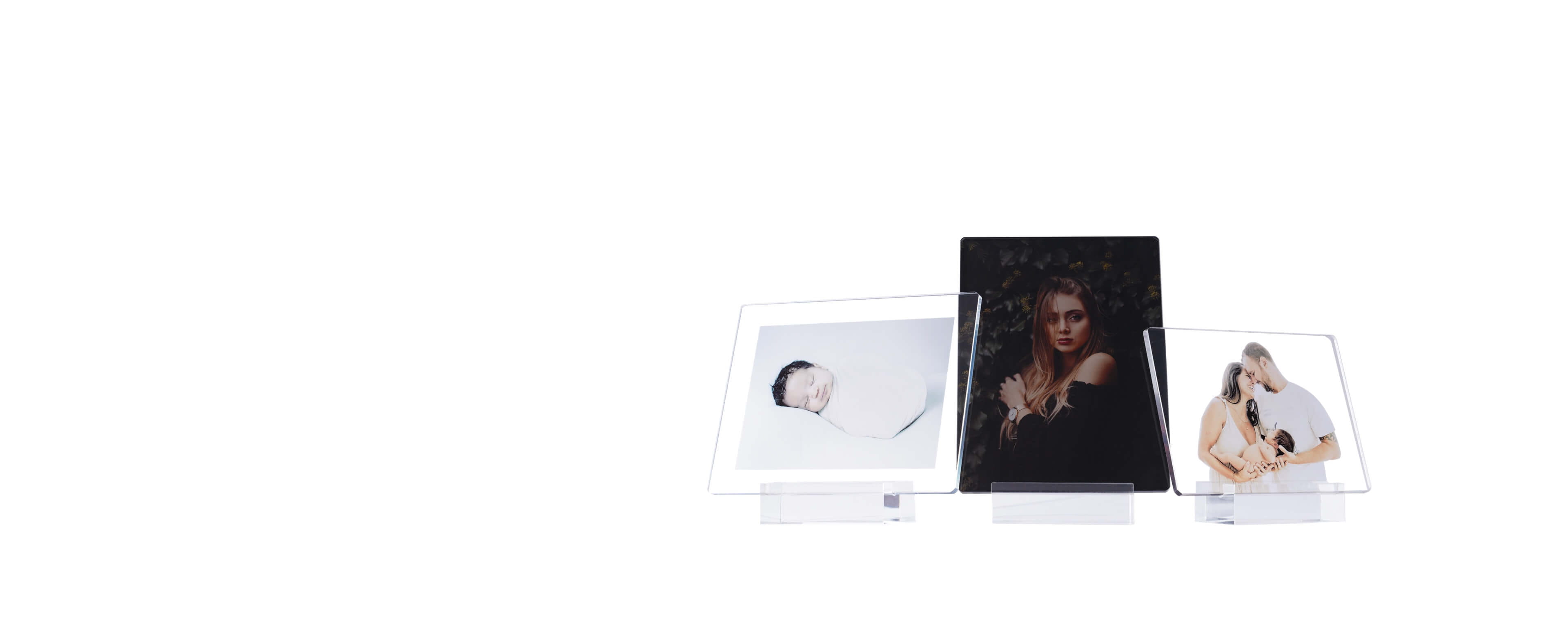 three acrylic photo stands in different sizes