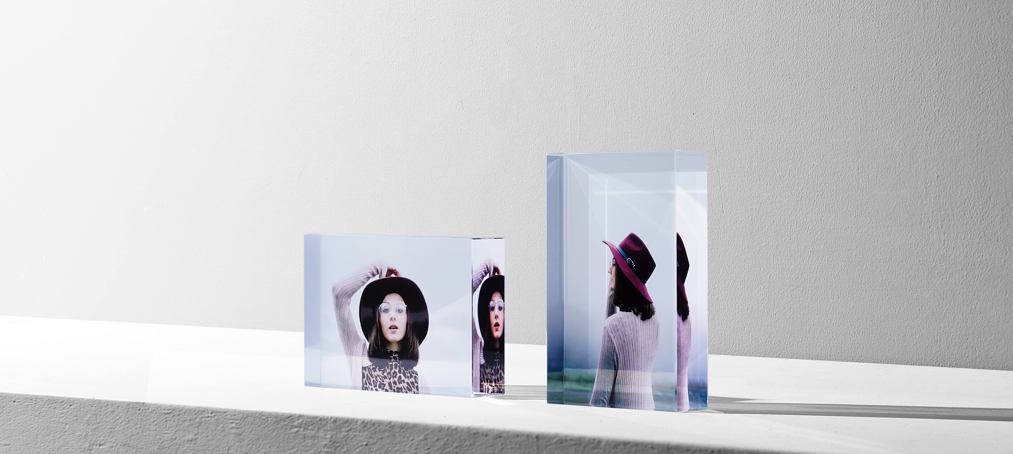 two crystal glass photo blocks in different orientation showing a woman in purple hat