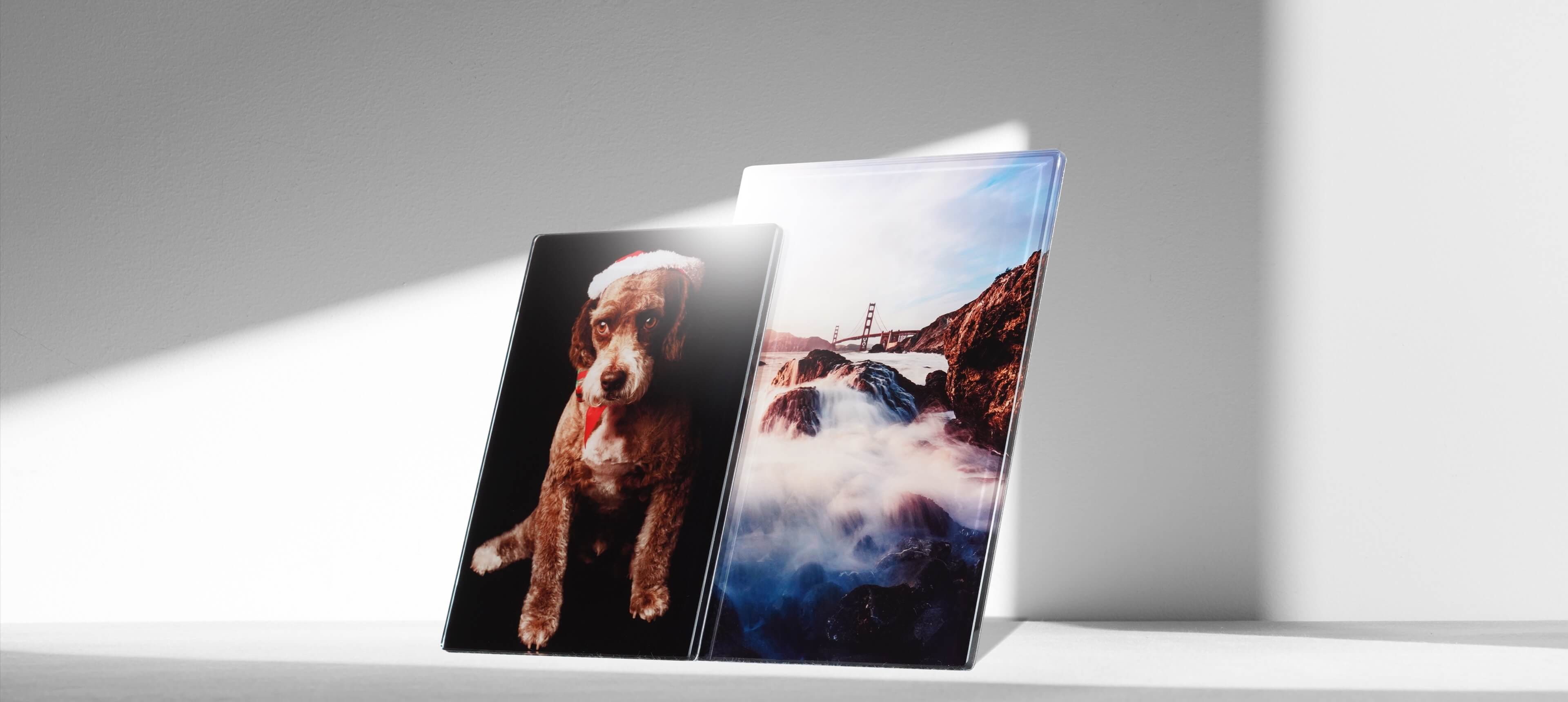 two crystal photo plaques stands on white table showing a dog and a landscape