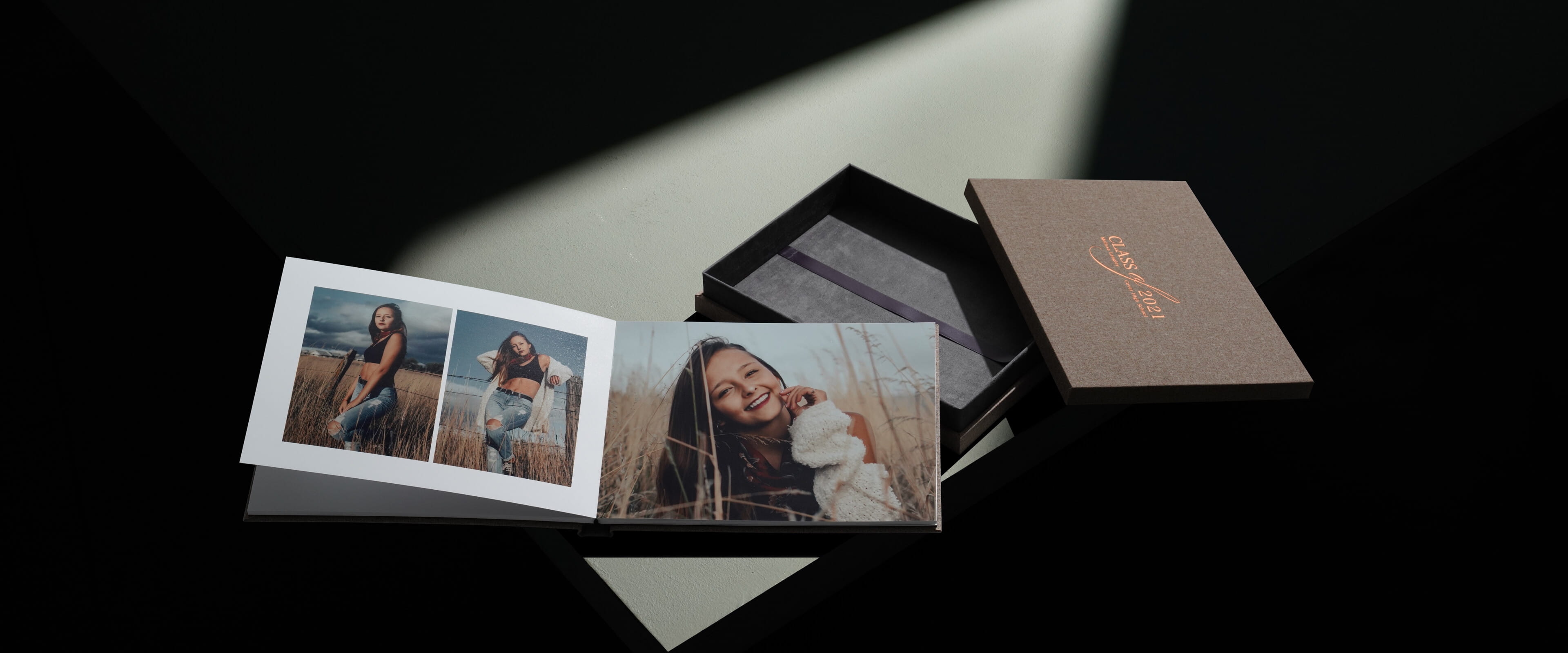 a design box album set showing a photo album opened resting on a linen box
