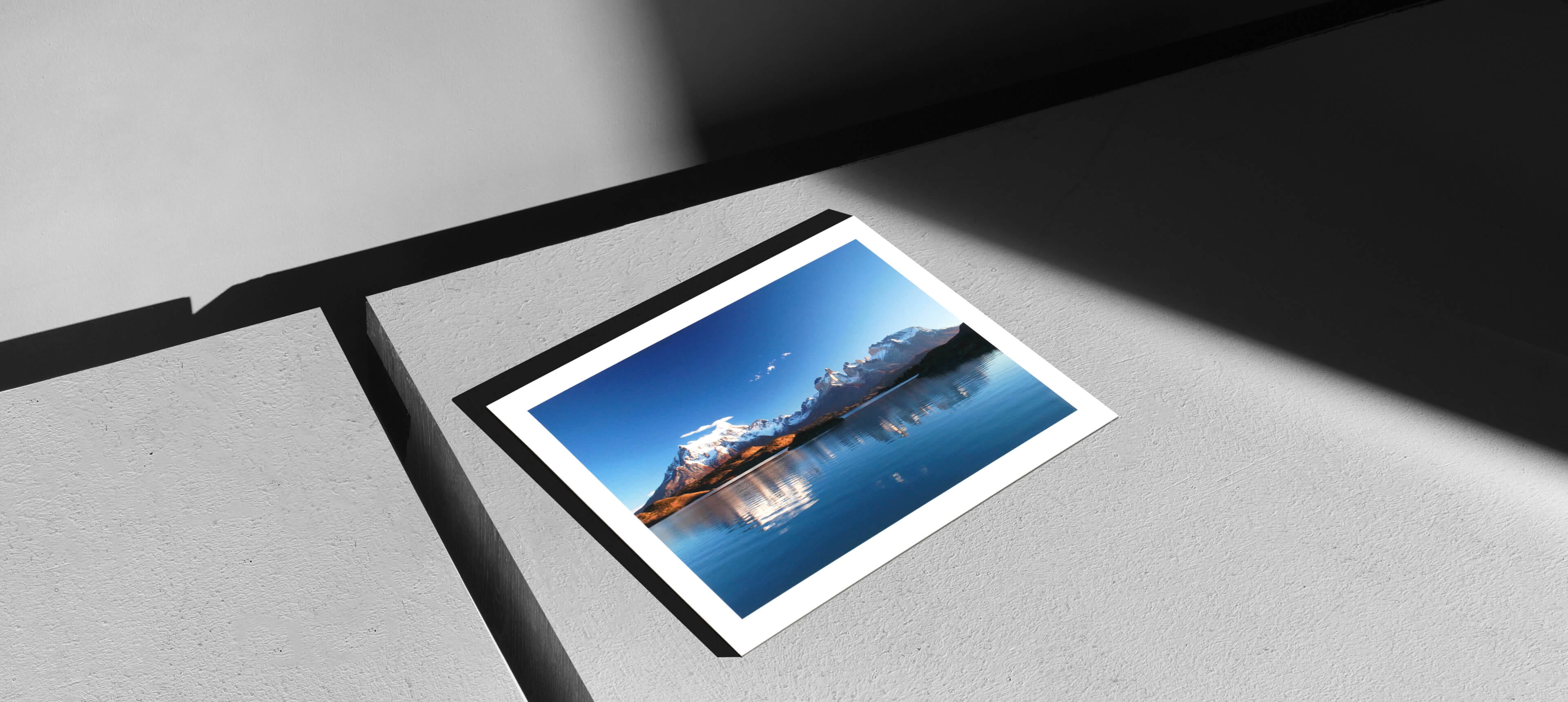 fine art print on grey table with photo showing mountains