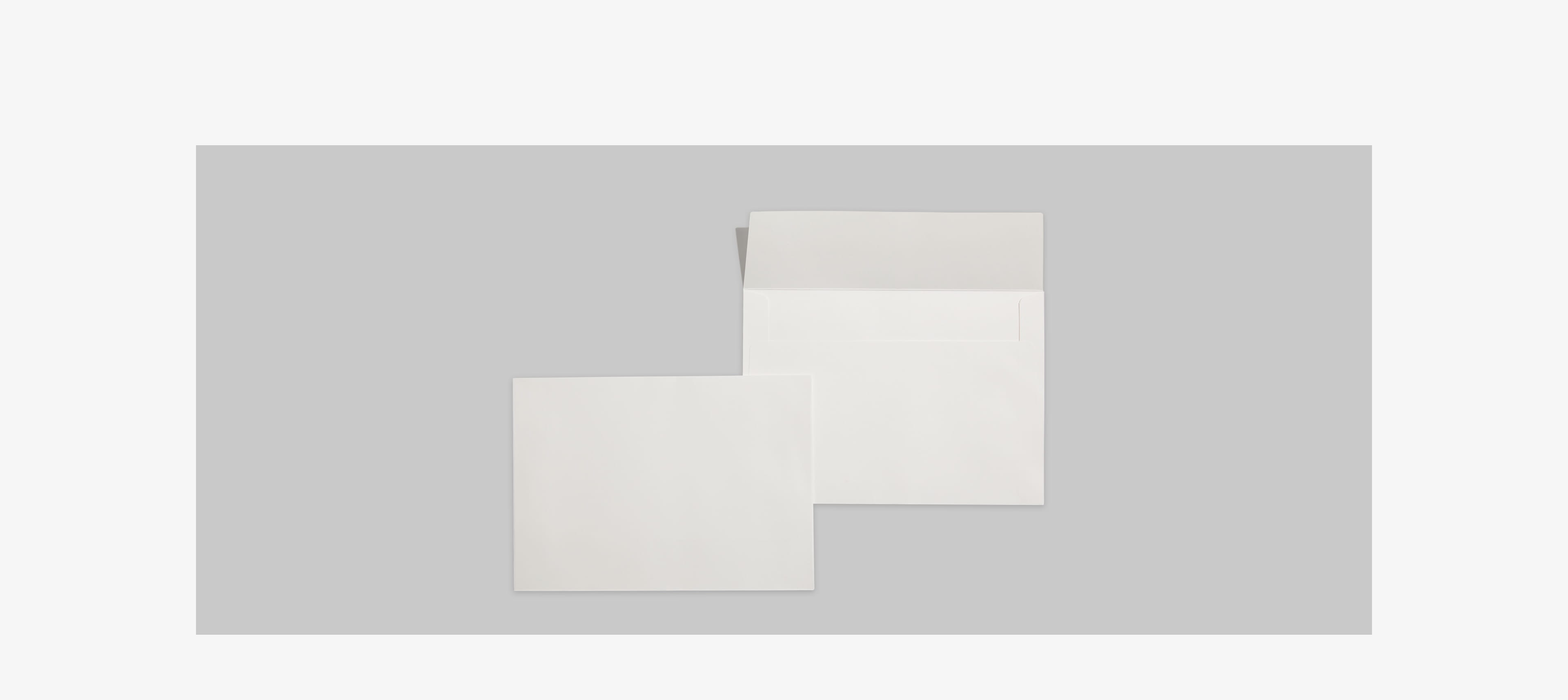 two envelopes on a grey table without cards