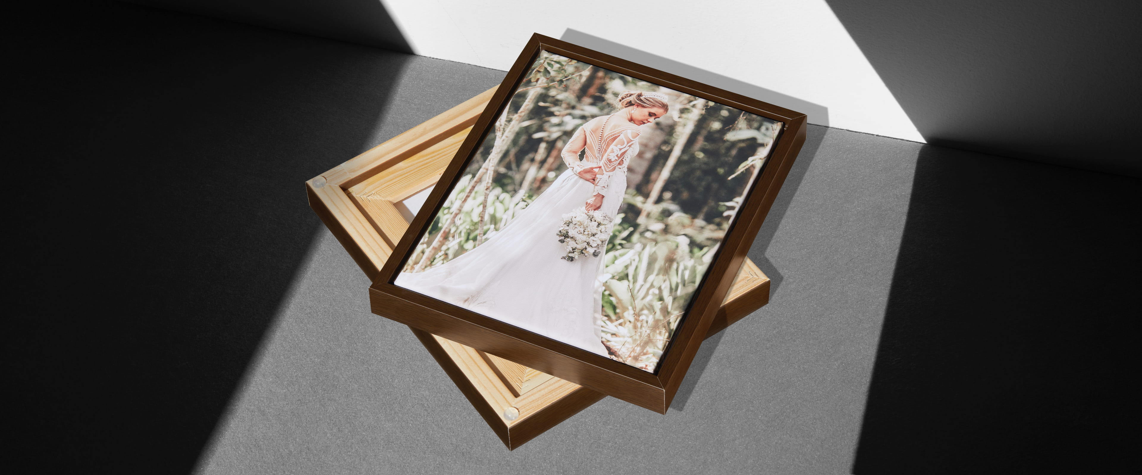 two framed canvases on grey surface with one showing a woman in wedding dress