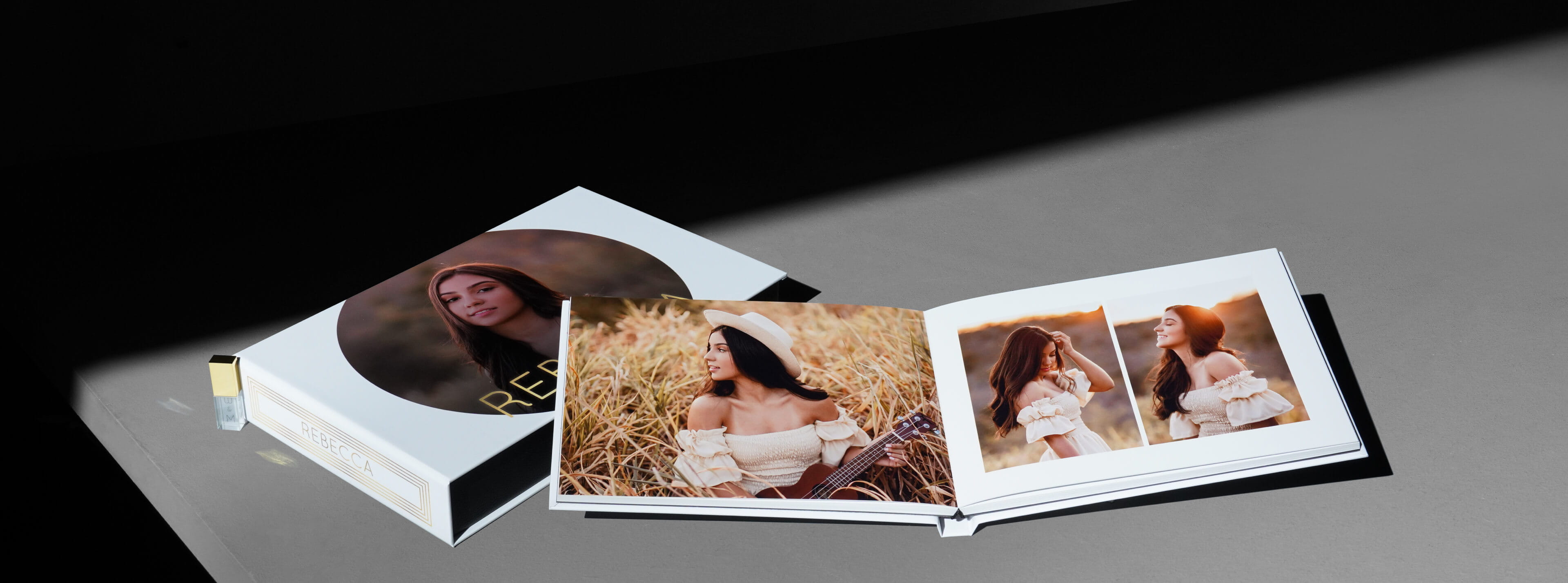 an image box album usb set showing a photo album opened resting on a printed box with usb