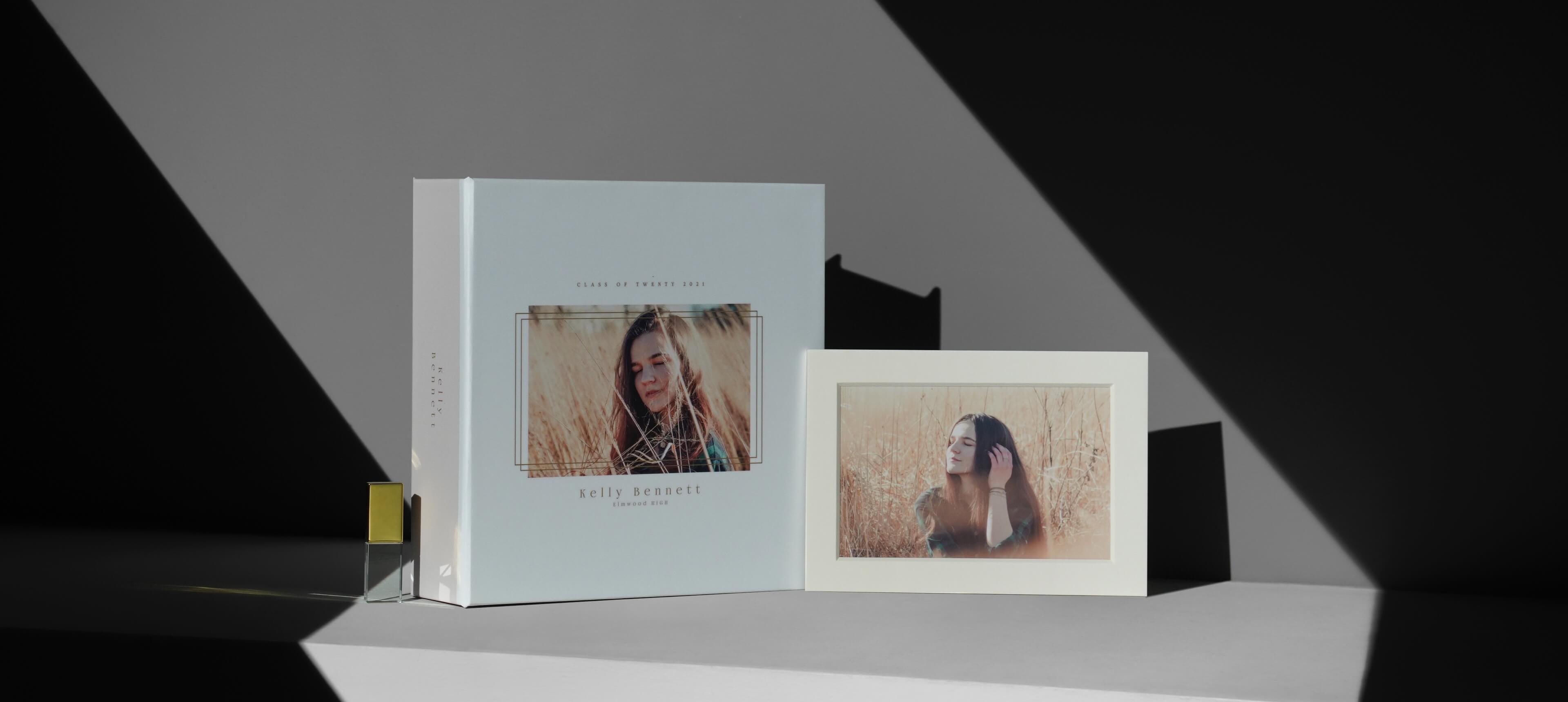 a image box set showing a matted photo and gold usb next to a box with a girl image printed on it