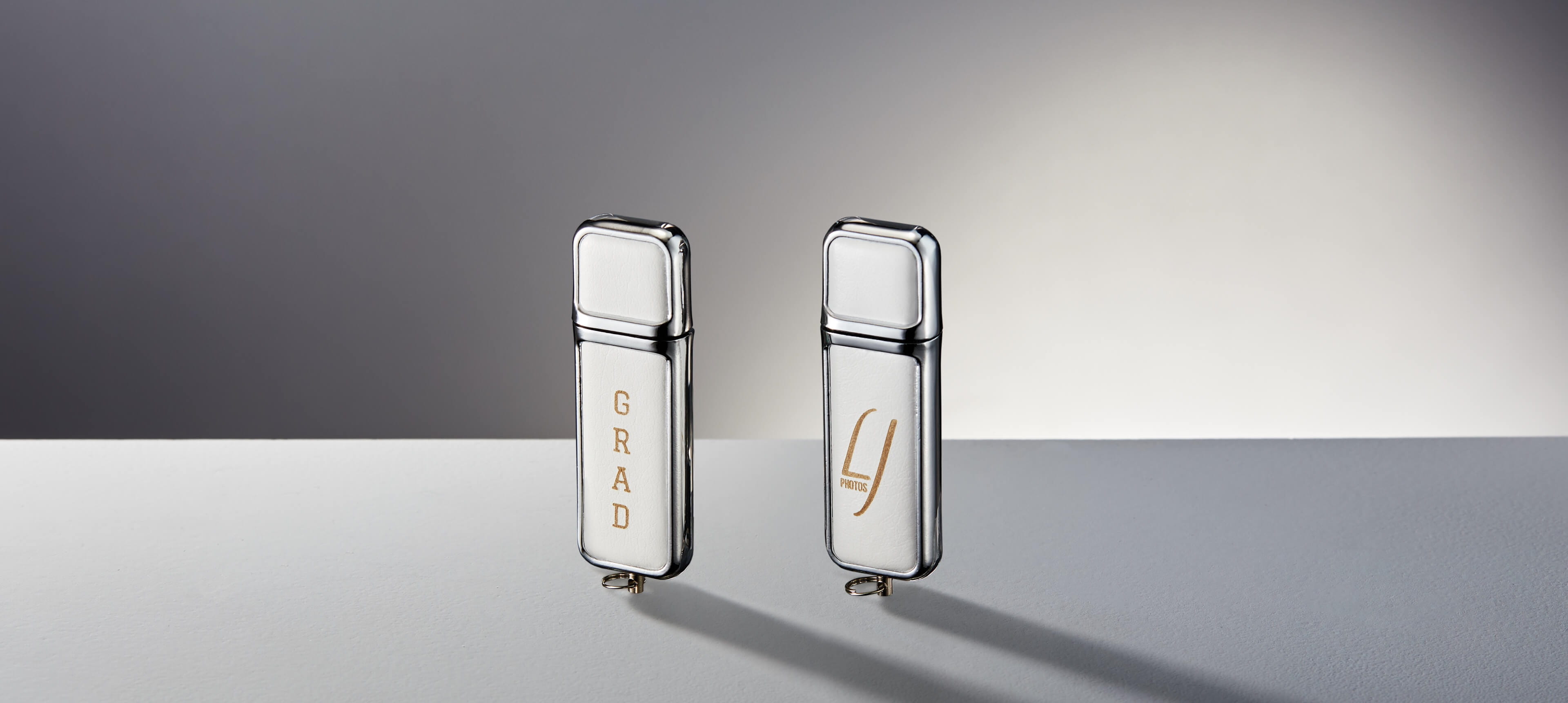 two custom usb drives in white leatherette with engraving