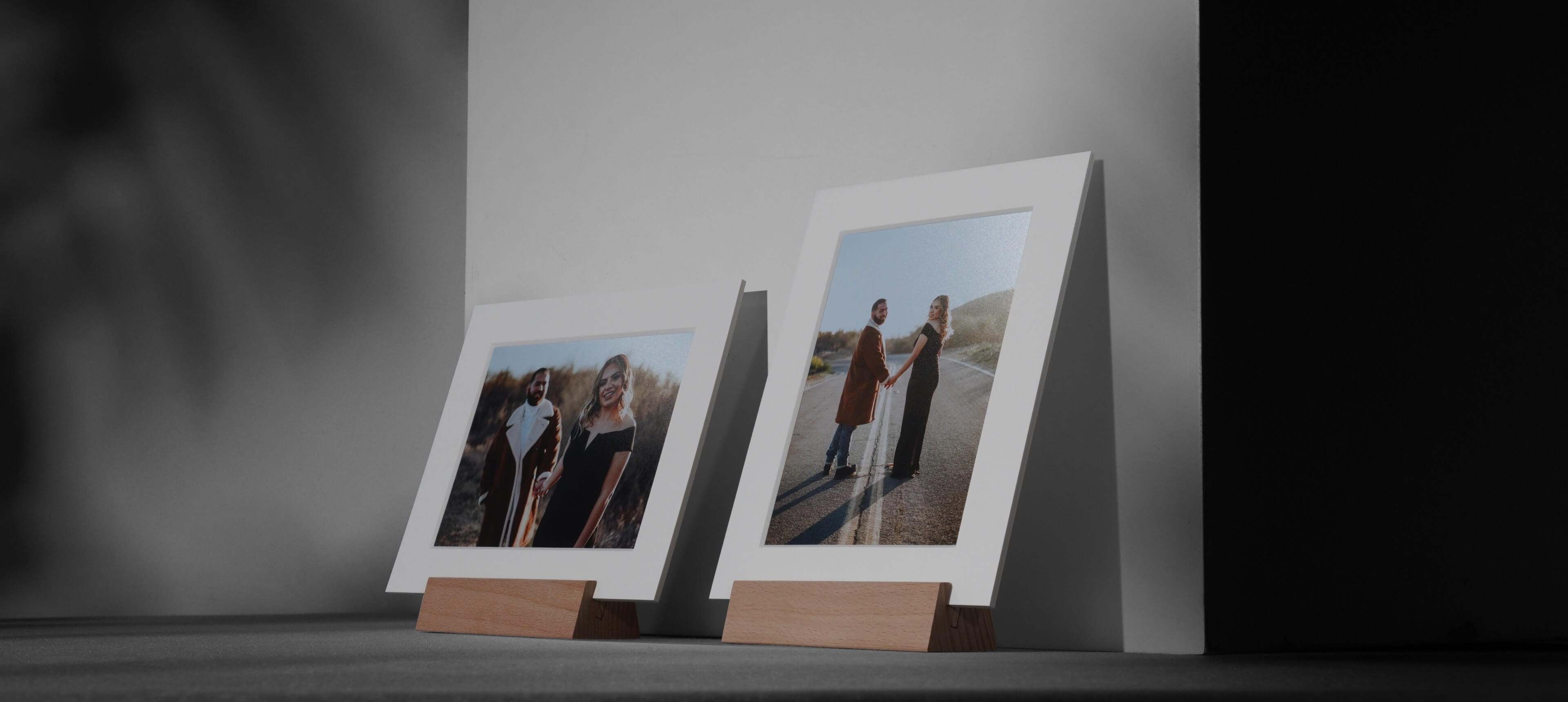two matted print stands on white table in different orientation showing a couple smiling