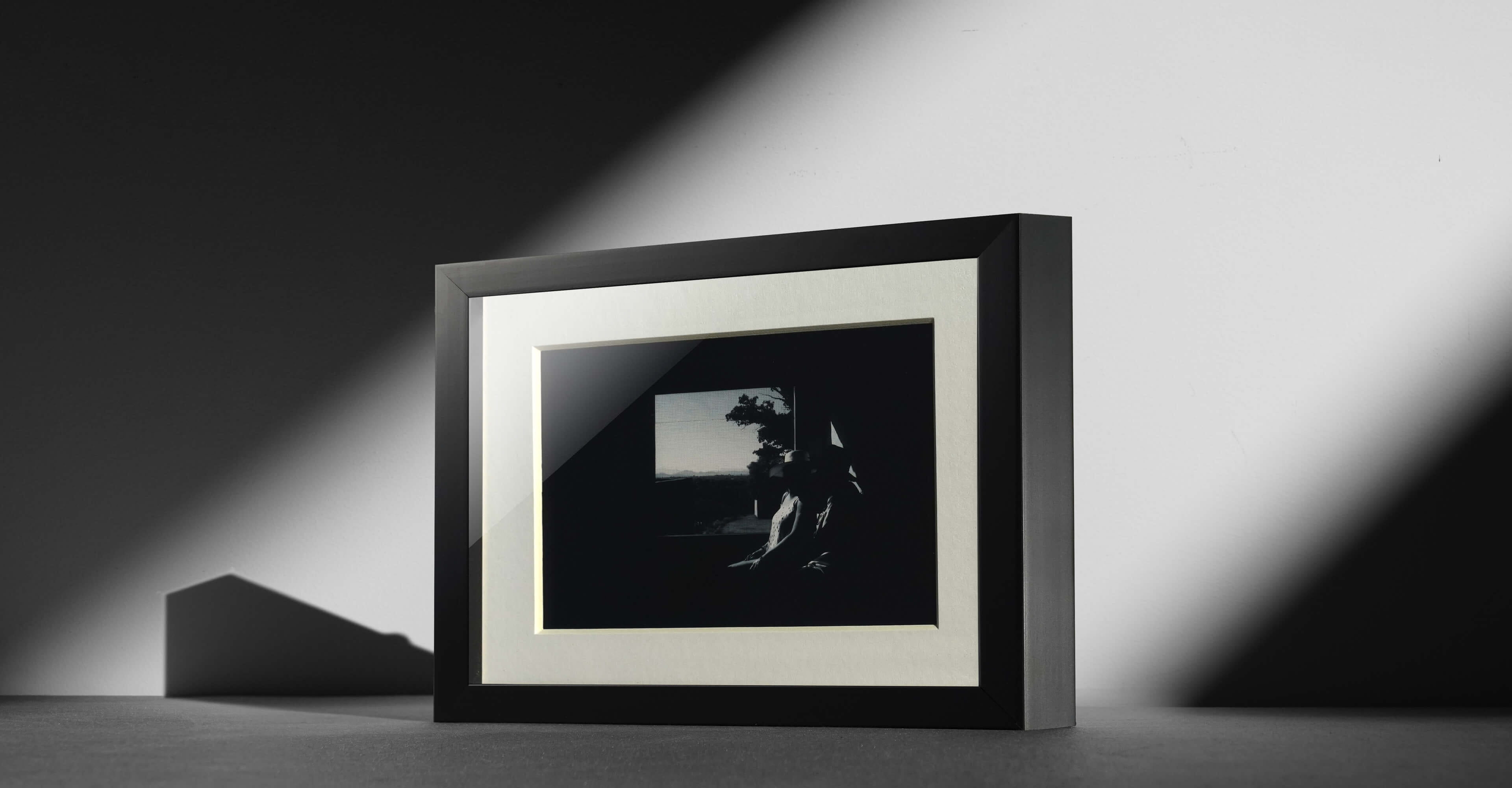 framed print with black frame and white atting showing black and white photo