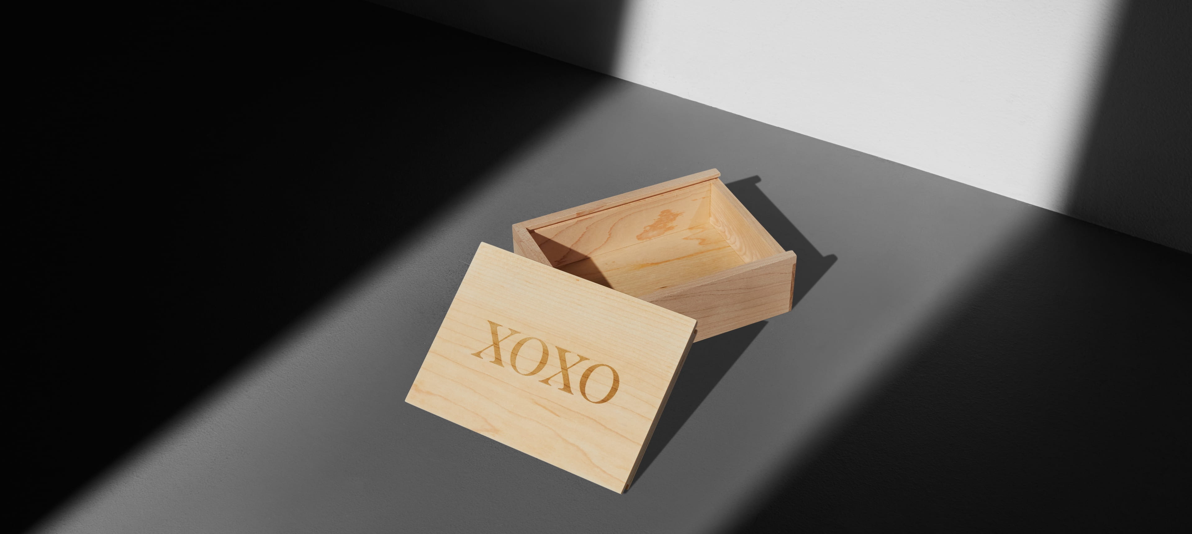 an wood box opened showing XOXO on the lid