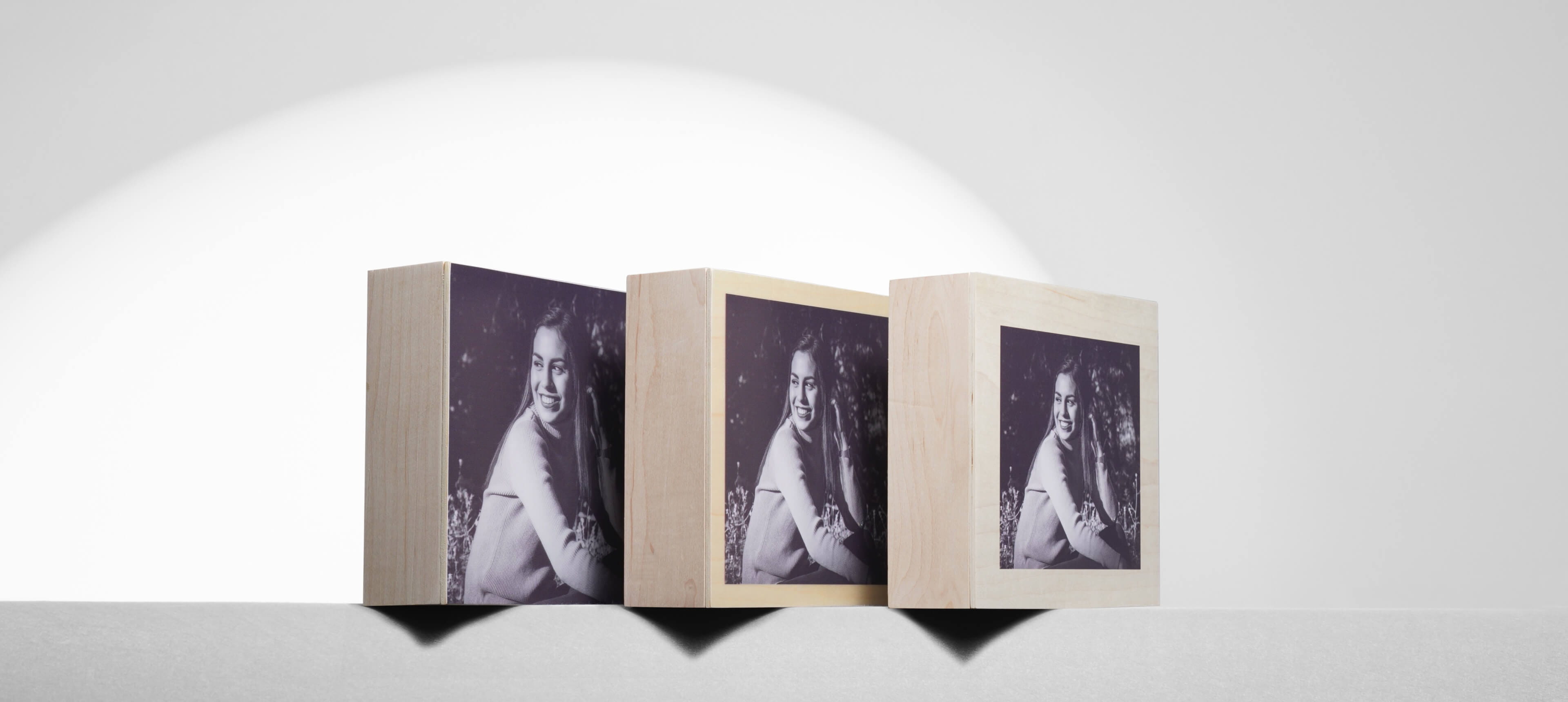 three wood boxes sitting next to each other with the same photo of a girl in three different border options