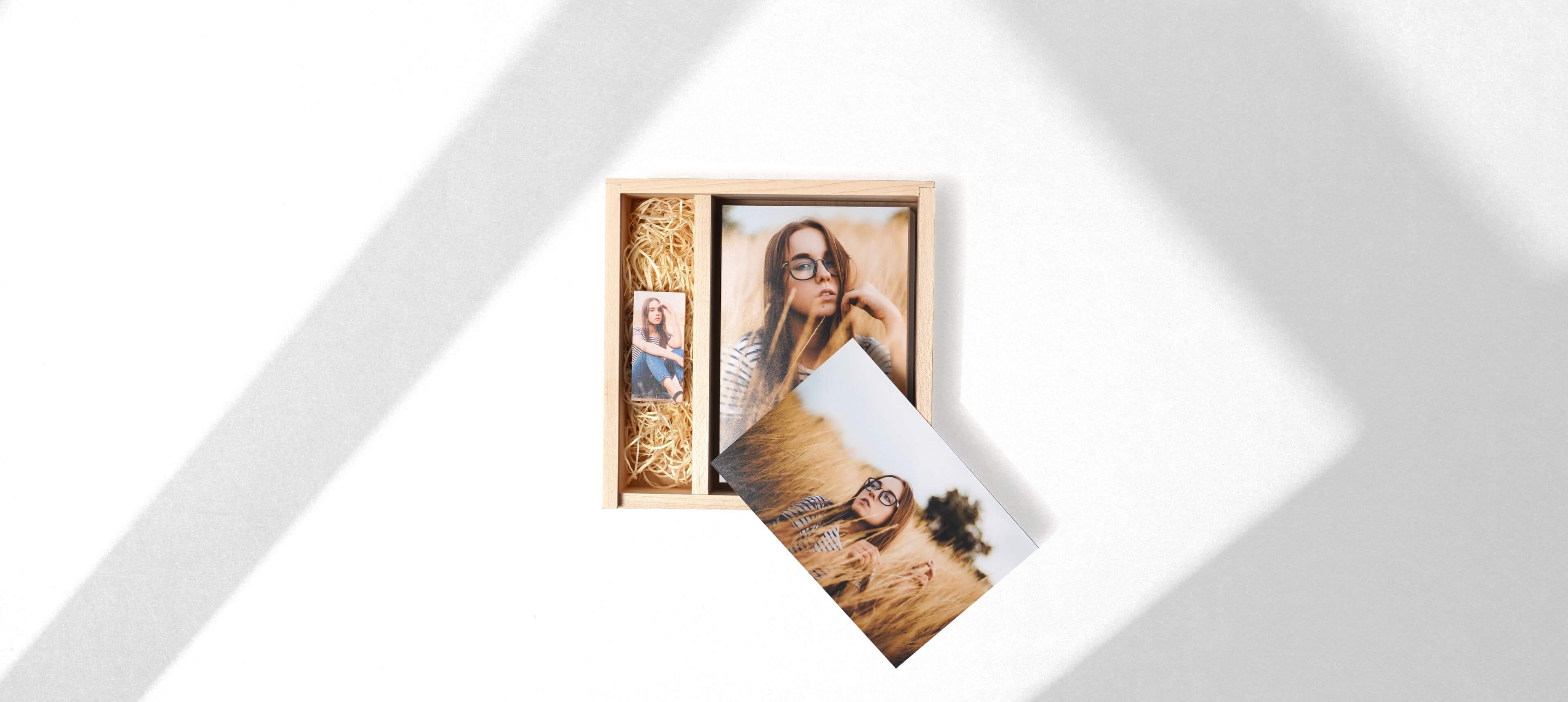 a wood box set showing a wood usb and prints of a girl inside a box