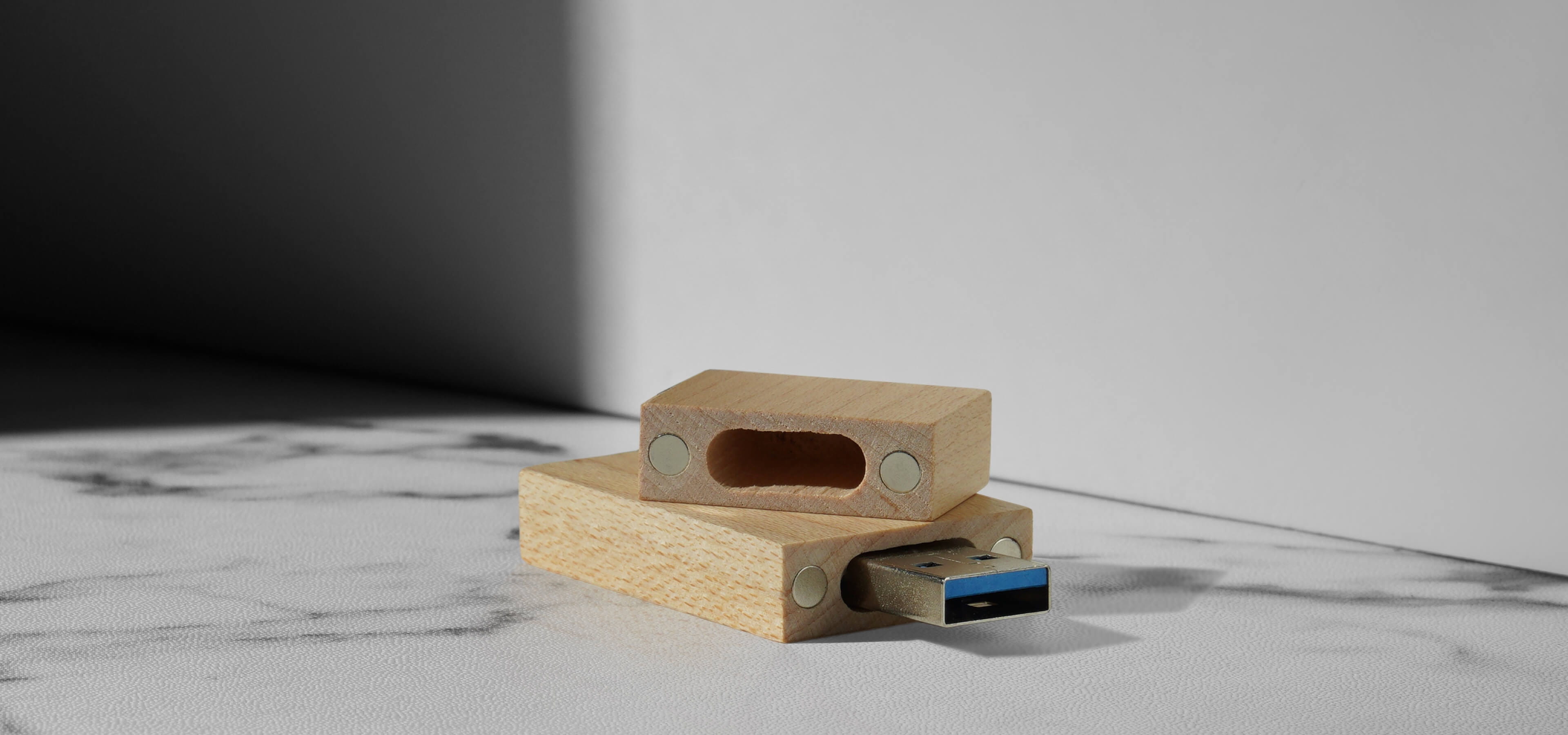 wood usb drive showing magnets on inside of cap sitting on table